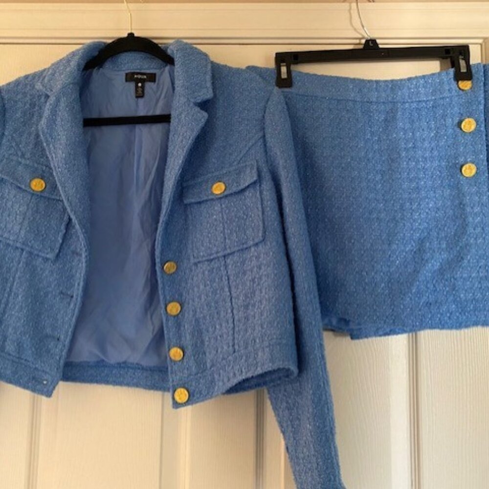 This is an Aqua blue jacket and skort set from bloomingdales